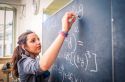girl_writing_maths_on_blackboard