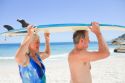 older-couple-with-surfboard