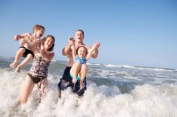 family_playing_in_surf